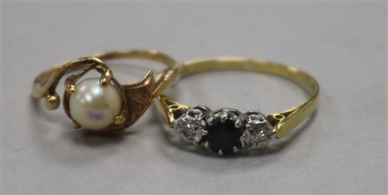 An early 20th century sapphire and diamond three stone ring and a 14ct gold and cultured pearl ring.